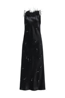 Black bias-cut slip dress by Not Just Pajama featuring rhinestones and feather details, perfect for elegant evening wear.