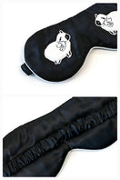 Black eye mask from Not Just Pajama loungewear, soft fabric for relaxation and sleep.