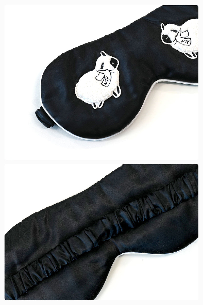 Black eye mask from Not Just Pajama loungewear, soft fabric for relaxation and sleep.