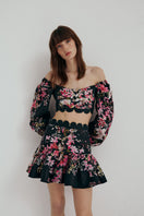 AISA FLORA top displayed on a hanger, featuring a floral pattern with lightweight fabric and a relaxed fit.