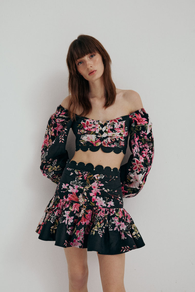 AISA Flora Mini Skirt in floral print, lightweight fabric, high waist design, shown on a model with neutral background.