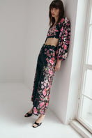 AISA Flora Pants in neutral color, featuring a relaxed fit and stylish design, shown on a model against a plain background.