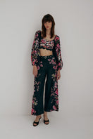 AISA Flora Pants in neutral fabric, featuring a relaxed fit with side pockets and a high-rise waistband, on a plain background.