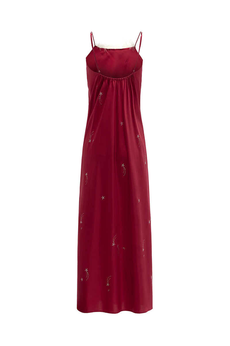 Bias-cut burgundy slip dress with rhinestones and feather embellishments, featuring a maxi length and elegant design.