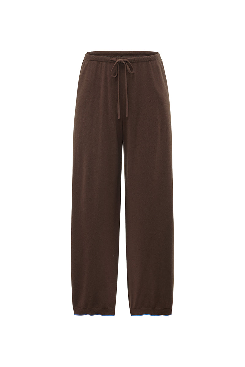 Unisex brown pants from Not Just Pajama featuring a relaxed fit and casual style, shown on a model.