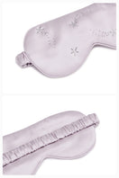 White and light purple rhinestone eye mask from Not Just Pajama, a stylish loungewear accessory with sparkling embellishments.