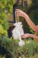 White top handle handbag with rhinestones and feather details from Not Just Pajama's collection.