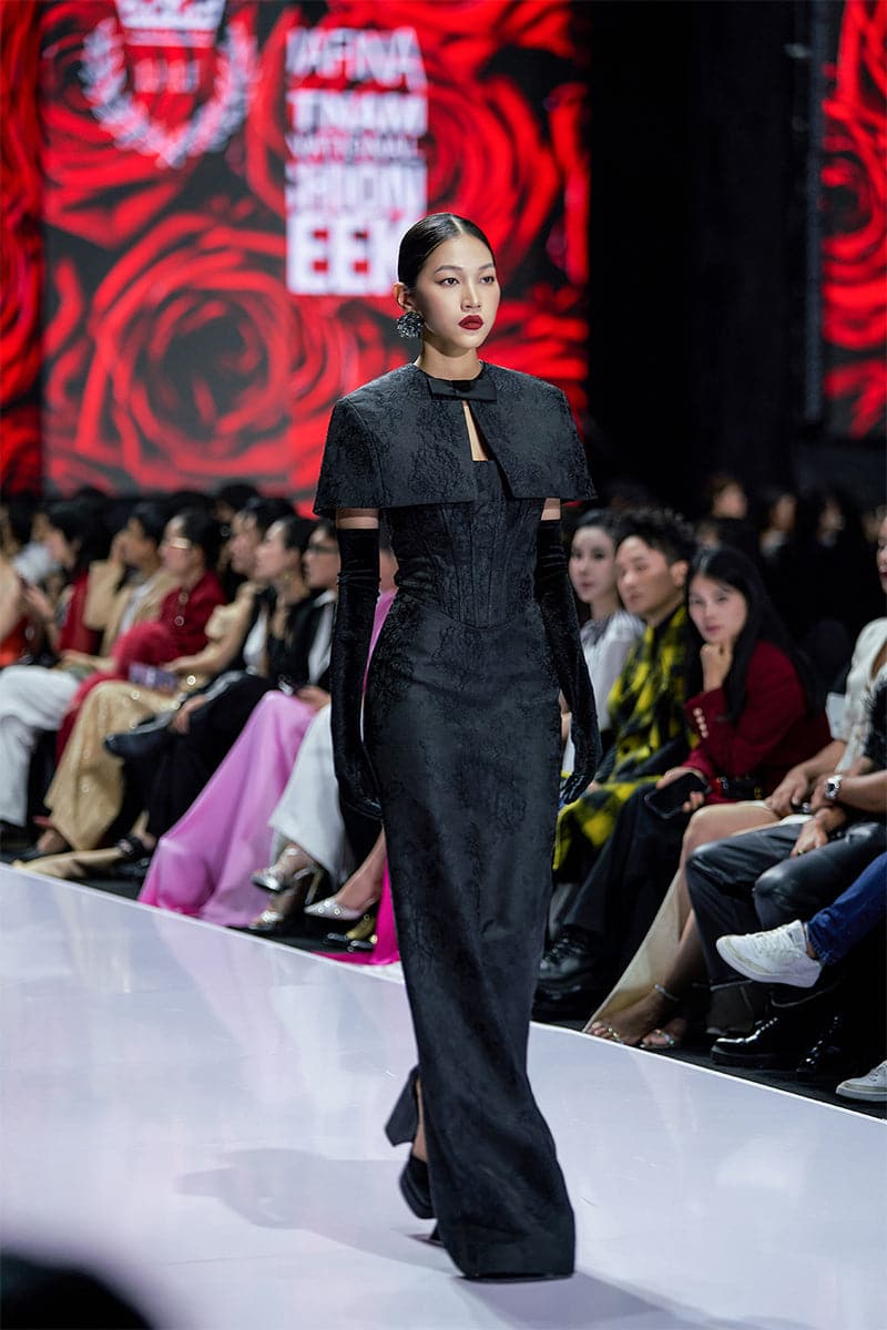 Black bustier gown with a mini cape by I.H.F, featuring a fitted bodice and stylish cape detail for elegant evening wear.