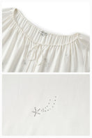 White feather robe with rhinestones, luxurious gown by Not Just Pajama featuring feather details and elegant design.