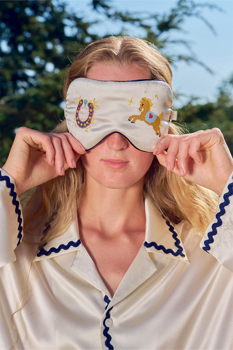 Pearl white embroidered eye mask from Not Just Pajama, soft loungewear accessory with delicate embroidery for comfortable relaxation.