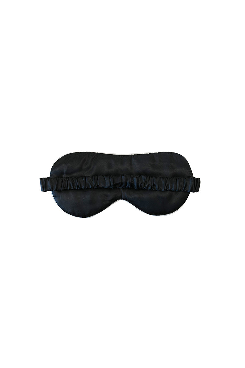 Black loungewear eye mask by Not Just Pajama, soft fabric for comfortable sleep and relaxation.