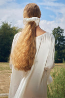 White feather gown with rhinestones by Not Just Pajama featuring elegant feather details and a luxurious, flowing design.