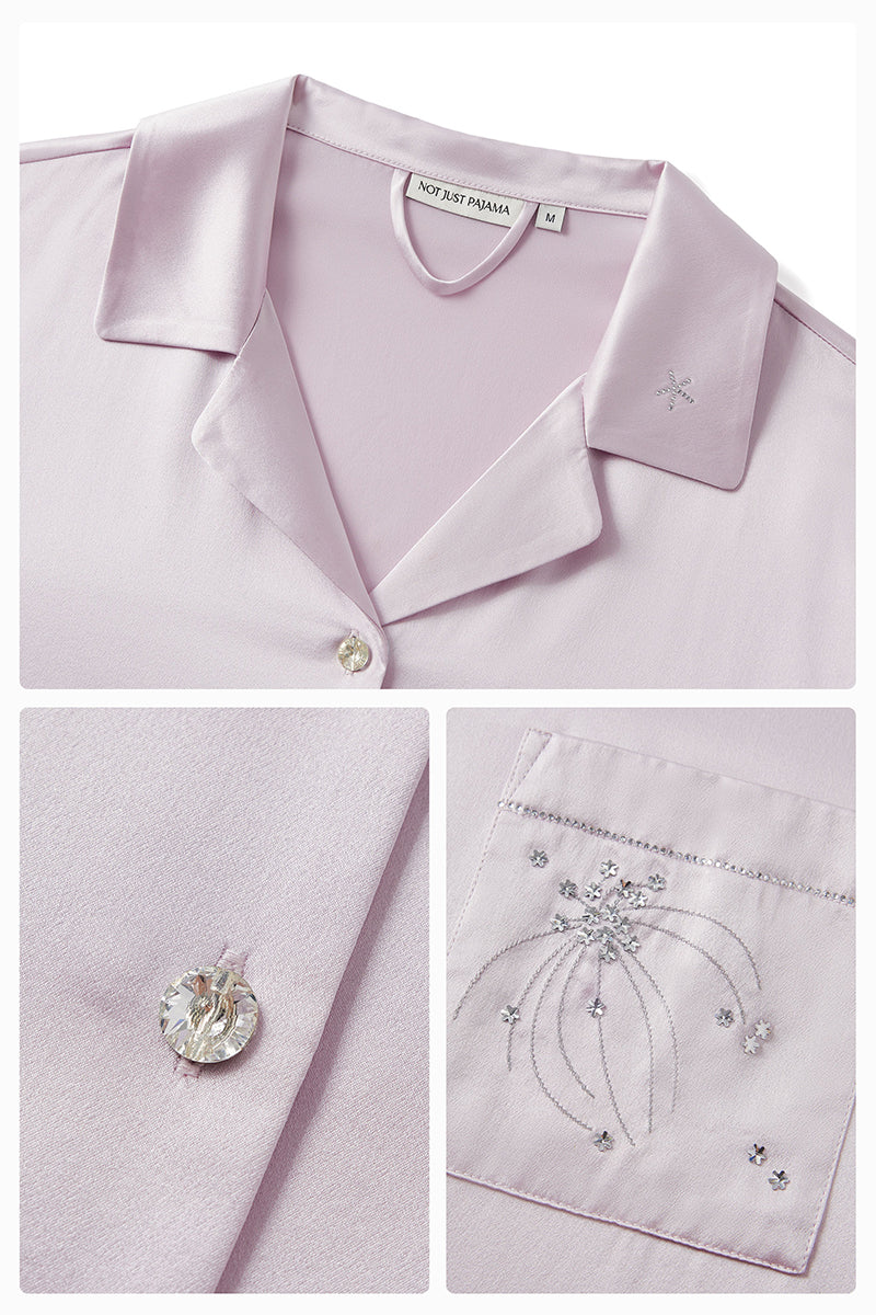 Light purple satin pajamas set with rhinestones from Not Just Pajama, featuring a long sleeve top and matching pants.