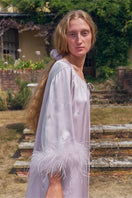 Light purple feather and rhinestone short robe from Not Just Pajama, styled as a midi dress with feather details and shimmering rhinestones.