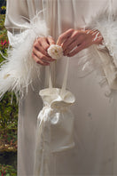 White rhinestone and feather top handle handbag by Not Just Pajama, featuring sparkling embellishments and elegant design.