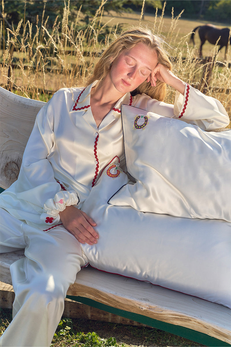 Pearl white loungewear pillowcase from Not Just Pajama, soft fabric with smooth texture, designed for comfortable sleep and relaxation.