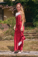 Bias-cut burgundy maxi dress with rhinestone embellishments and feather accents, featuring a slip silhouette by Not Just Pajama.