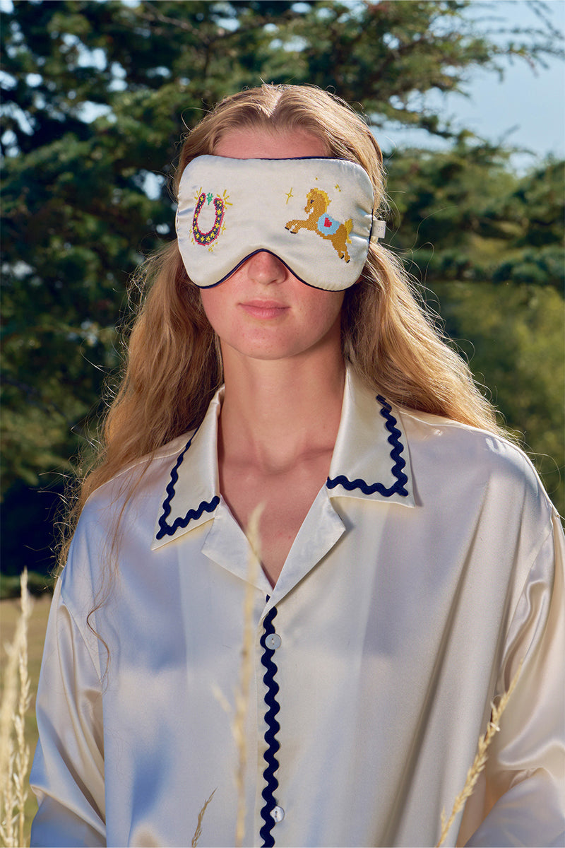 Pearl white embroidered eye mask from Not Just Pajama, soft loungewear accessory for restful sleep and relaxation.