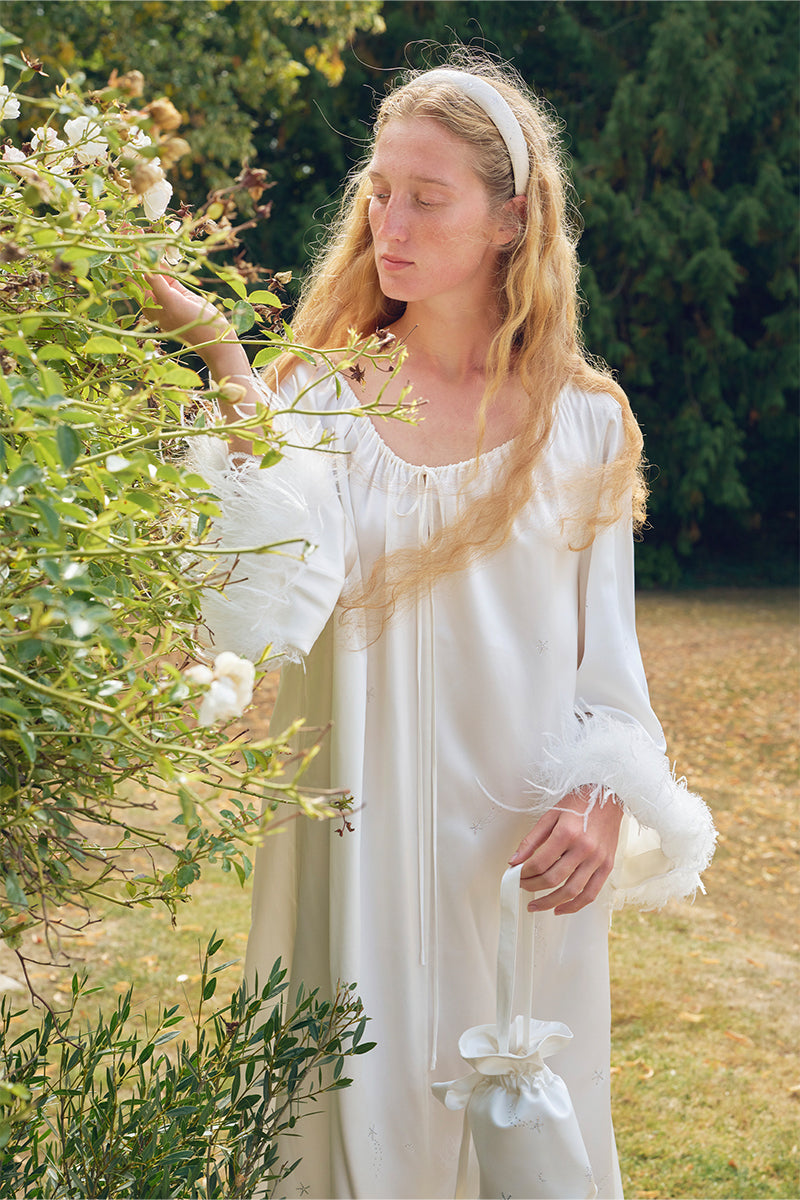 White feather gown with rhinestone accents by Not Just Pajama, featuring luxurious feather details and elegant robe design.