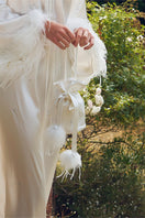 White rhinestone and feather handbag with top handle, designed by Not Just Pajama, featuring sparkling embellishments and elegant style.