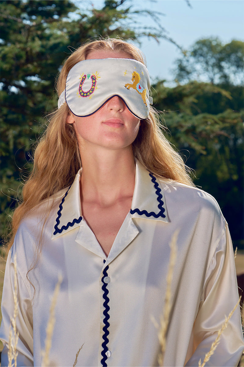 Pearl white embroidered eye mask from Not Just Pajama, soft loungewear accessory with delicate embroidery for comfortable relaxation.