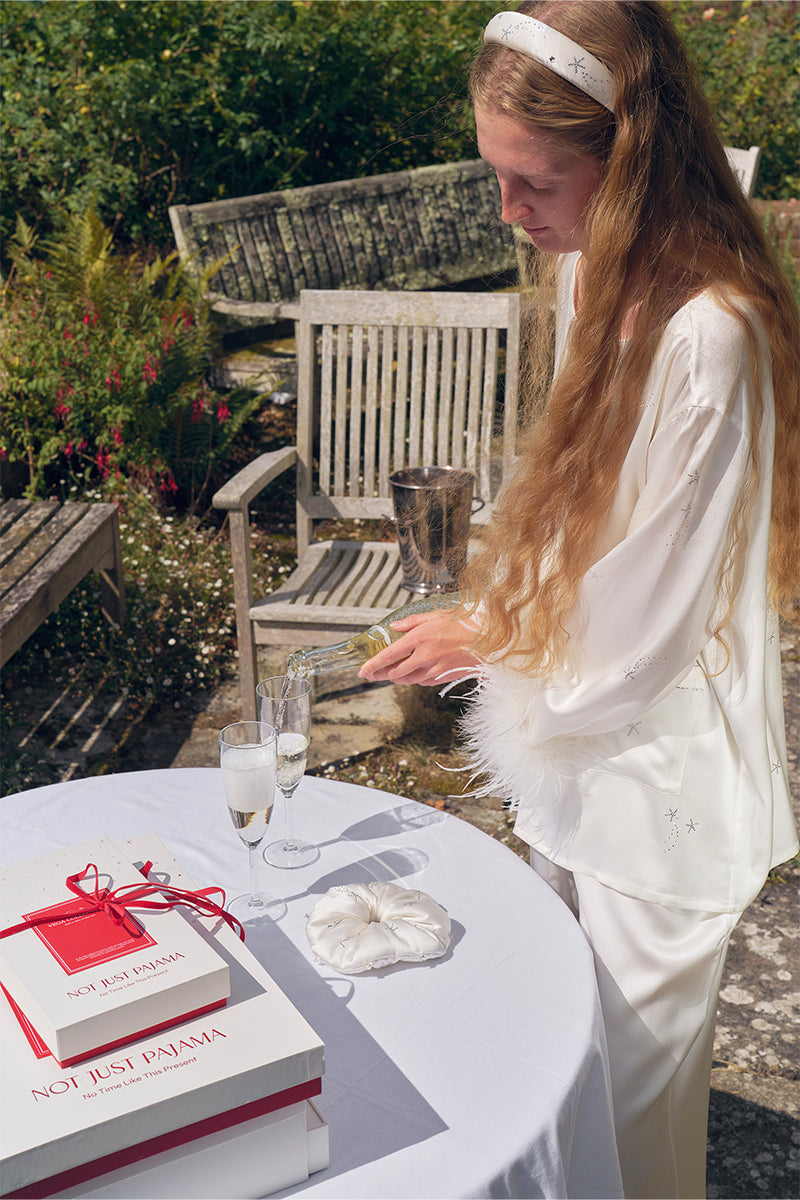 White feather long-sleeve pajama set with rhinestones from Not Just Pajama, featuring feather details and soft fabric.