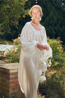 White feathered gown with rhinestone embellishments, elegant robe from Not Just Pajama featuring luxurious feather details.