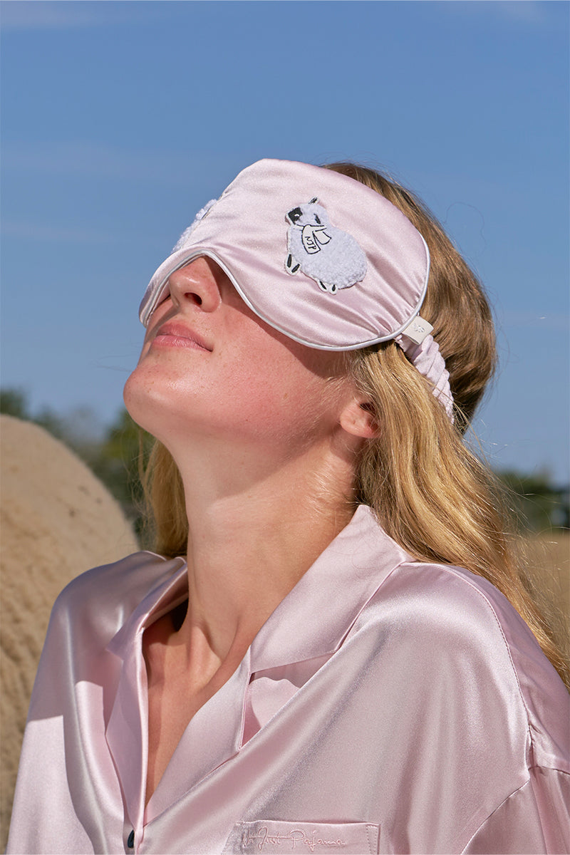 Pink eye mask from Not Just Pajama, a comfortable loungewear accessory for relaxing or sleeping.