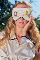 Pearl white embroidered eye mask from Not Just Pajama, soft loungewear accessory with delicate eye embroidery and comfortable fabric.