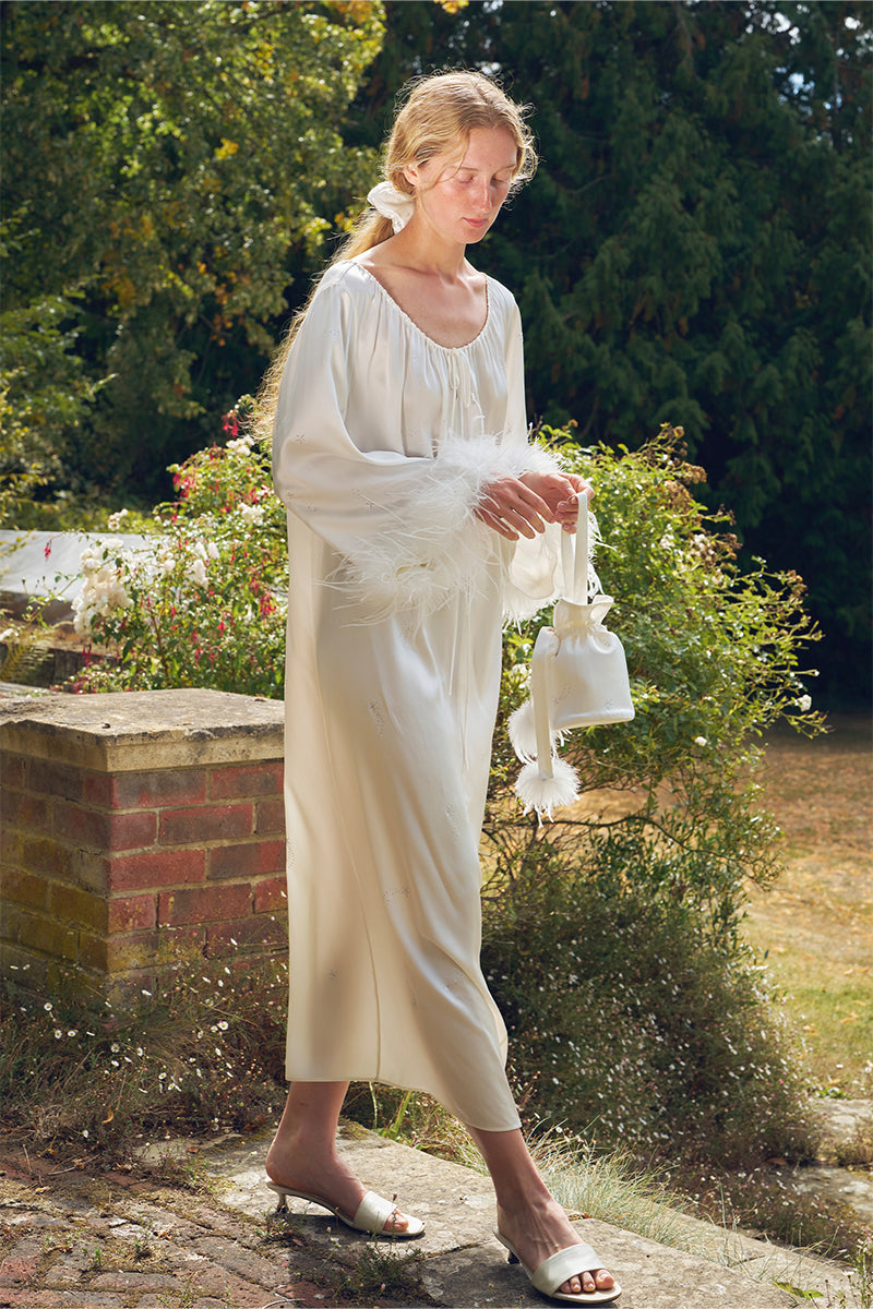 White feather robe with rhinestones, elegant gown by Not Just Pajama featuring luxurious feather details and sparkling embellishments.