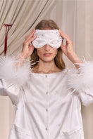 White and light purple rhinestone eye mask from Not Just Pajama, featuring a soft loungewear style with sparkling rhinestone decorations.