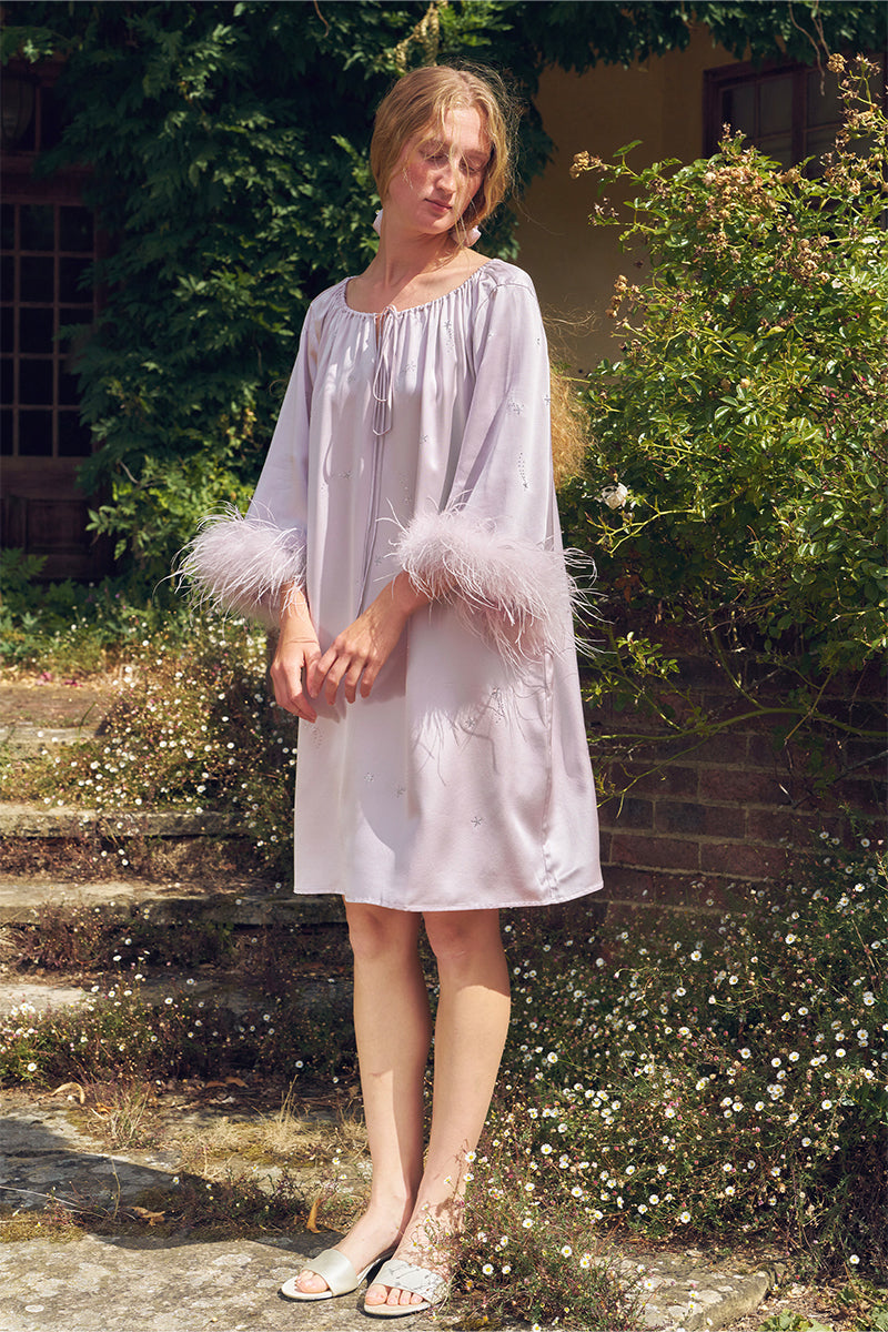 Light purple short robe with rhinestones and feather details, stylish midi dress from Not Just Pajama featuring elegant feather accents.