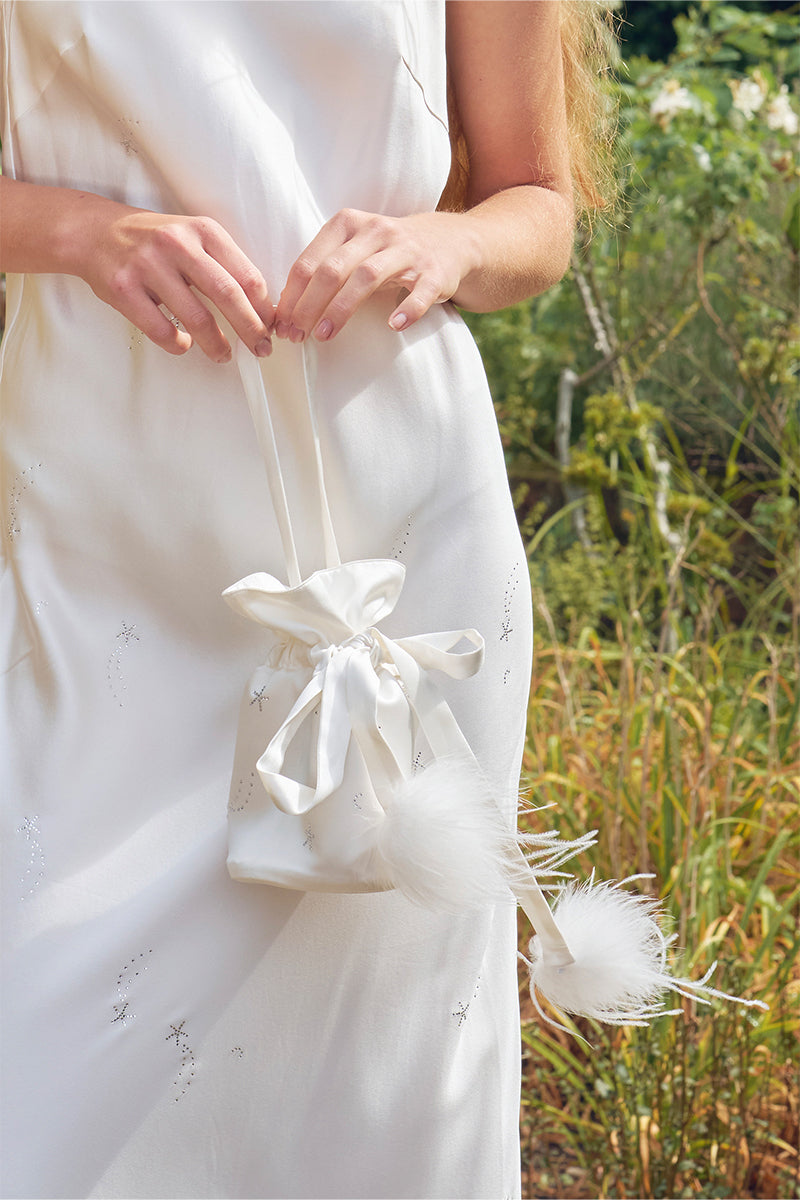 White top handle handbag with rhinestones and feather details, stylish and elegant by Not Just Pajama.