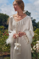 White feather gown with rhinestone embellishments by Not Just Pajama, featuring a luxurious feather robe with intricate details.