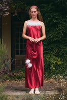 Bias-cut burgundy slip dress with rhinestones and feather embellishments, featuring a maxi length and elegant design.