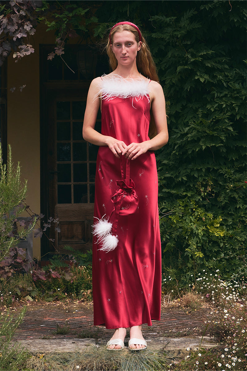 Bias-cut burgundy slip dress with rhinestones and feather embellishments, featuring a maxi length and elegant design.