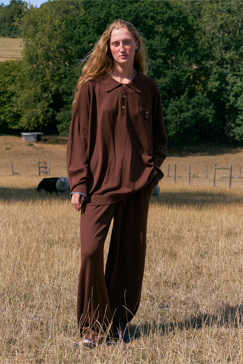 Unisex brown pants from Not Just Pajama featuring a relaxed fit and casual style, shown on a model.