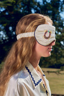 Pearl white embroidered eye mask from Not Just Pajama loungewear, soft fabric with decorative embroidery for comfortable sleep.
