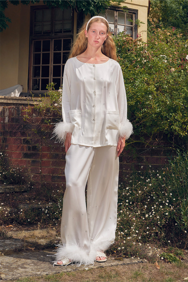 White feather long-sleeve pajamas set with rhinestone accents, stylish and comfortable by Not Just Pajama.