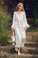 White feather gown with rhinestone accents from Not Just Pajama, featuring luxurious feather details and elegant design.