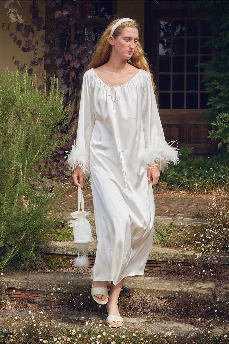White feather gown with rhinestone accents from Not Just Pajama, featuring luxurious feather details and elegant design.