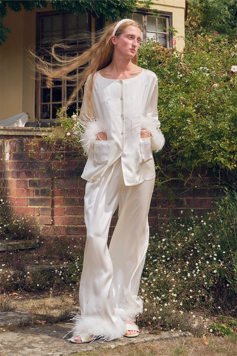 White feather long-sleeve pajamas set with rhinestones from Not Just Pajama, featuring soft fabric and elegant feather detailing.