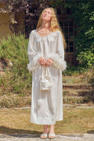 White feather gown with rhinestone accents by Not Just Pajama, featuring elegant feathers and intricate detailing.