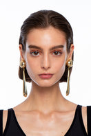 Silvia Gnecchi DROP GOLD EARRING showcasing sleek gold earrings with elegant drop design, on a plain background.