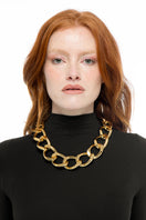 Gold Farah necklace by Silvia Gnecchi featuring a delicate chain and elegant pendant on a neutral background.