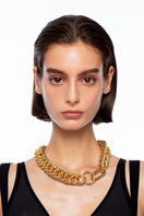 Gold Mariana necklace by Silvia Gnecchi featuring a delicate chain and elegant pendant, showcased on a neutral background.