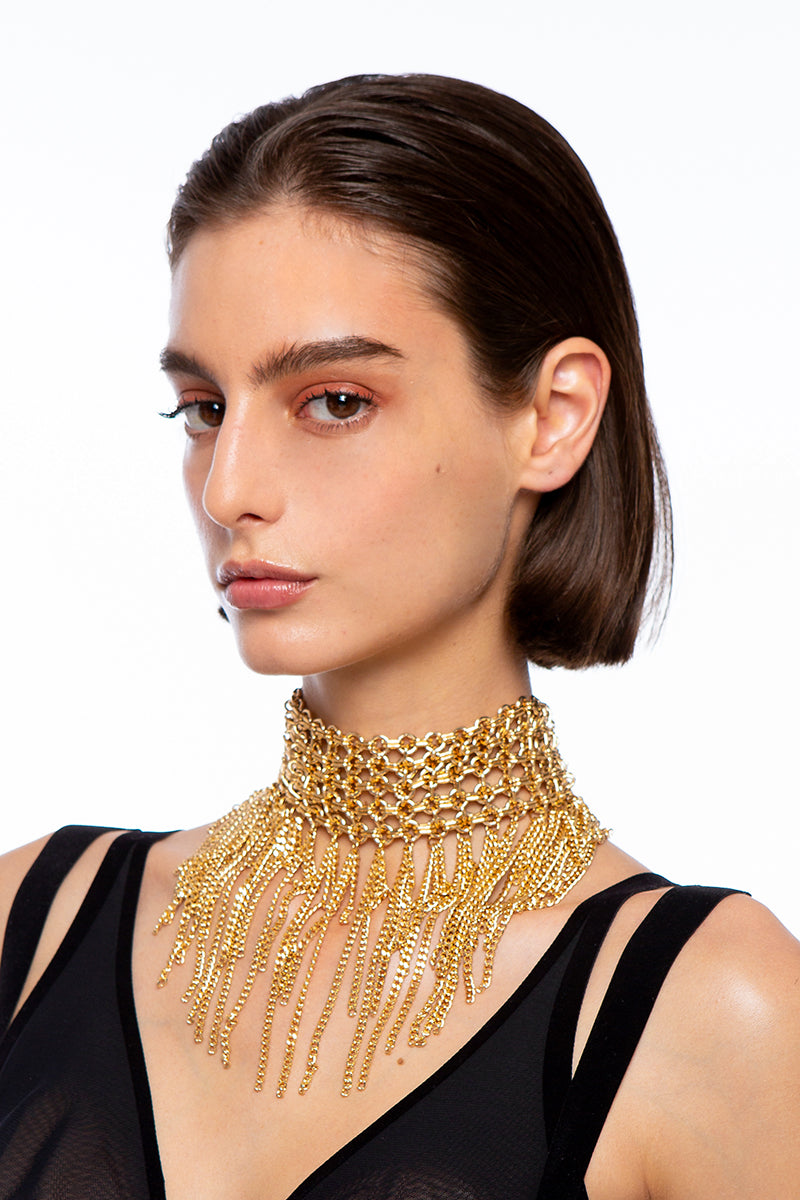 Silvia Gnecchi Dalida Gold Necklace featuring delicate chain and elegant pendant on a plain background