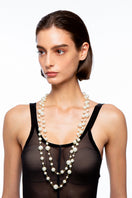 Silvia Gnecchi Aura Pearl Necklace featuring elegant white pearls on a delicate chain, showcasing a sophisticated jewelry piece.
