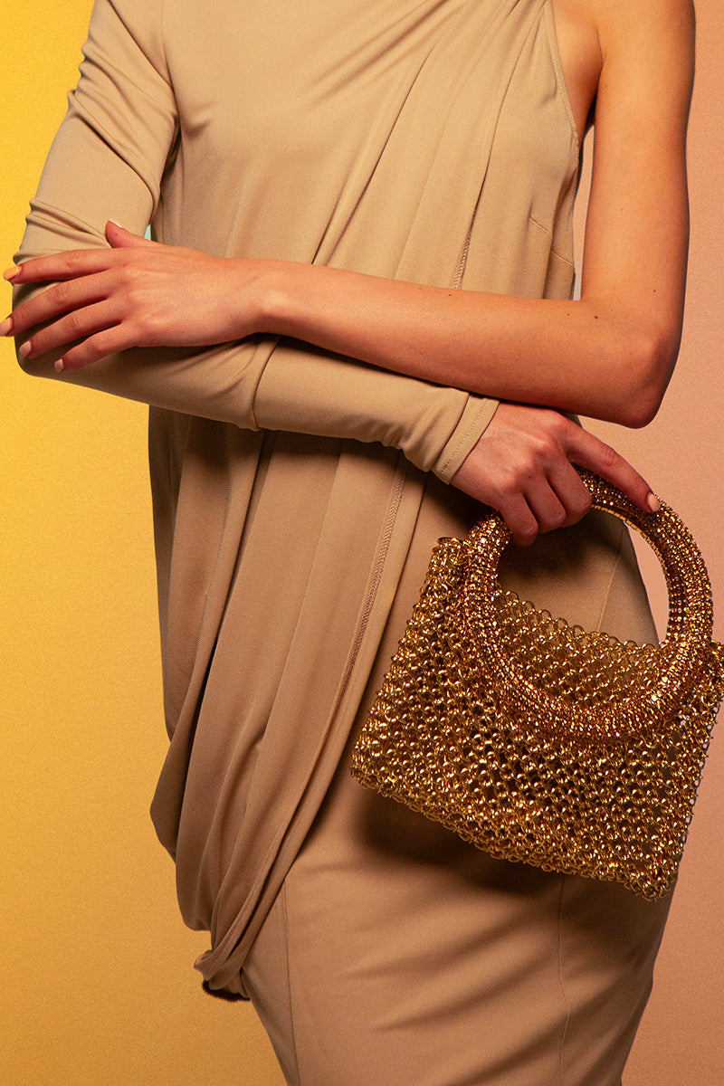 Silvia Gnecchi Luna Chain Bag, a stylish top handle bag with a gold chain strap and elegant design, on a neutral background.