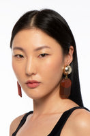 Gold earrings from Silvia Gnecchi's Norah collection featuring elegant, minimalist jewelry design.